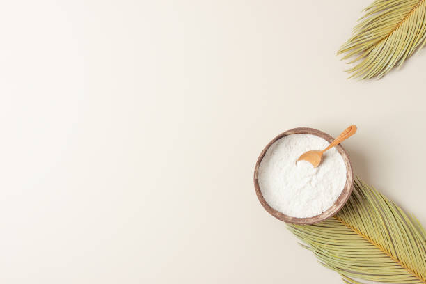 collagen powder in bowl with measure spoon with palm leaves on pastel beige background. flat lay, copy space - face powder imagens e fotografias de stock