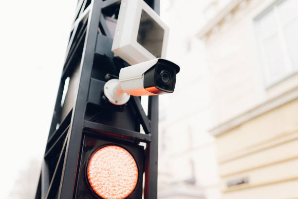 istock Traffic lights over cloudy sky. Traffic light with surveillance camera 1313098003