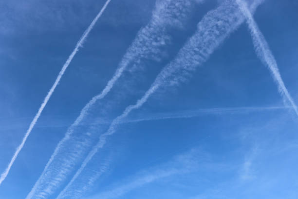 istock Blue sky with plane trails. Traces of planes and clouds. 1313098994