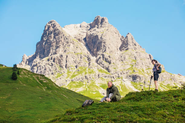 istock Two hikers in the alpine mountain countryside 1313099996