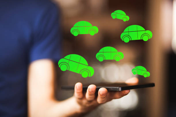 istock man holding tablet with car icons 1313103271