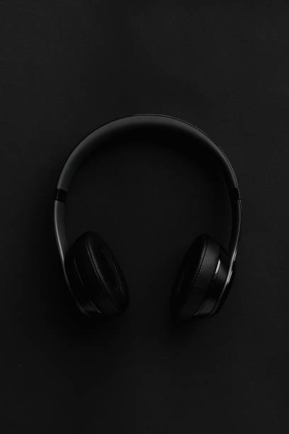 istock black headphones on a black background 1313104322