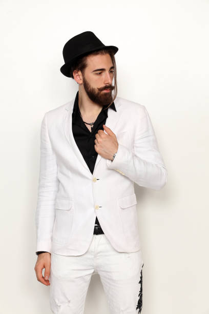 istock Attractive young male model with long hair and beard is posing in studio. 1313105625