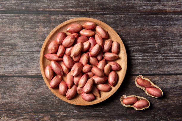 istock Raw fresh peeled peanut on wood background 1313106777