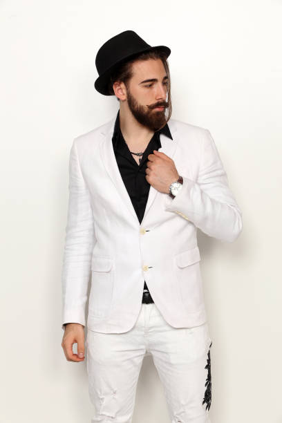 istock Attractive young male model with long hair and beard is posing in studio. 1313107845