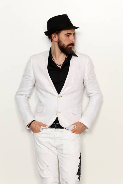istock Attractive young male model with long hair and beard is posing in studio. 1313108047