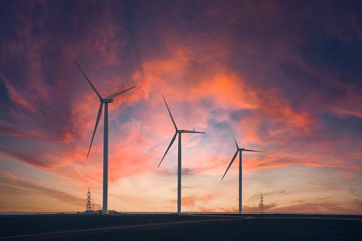 Windmills for electric power production at sunset