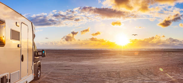 istock Motorhome on a sandy beach by the sea 1313109013