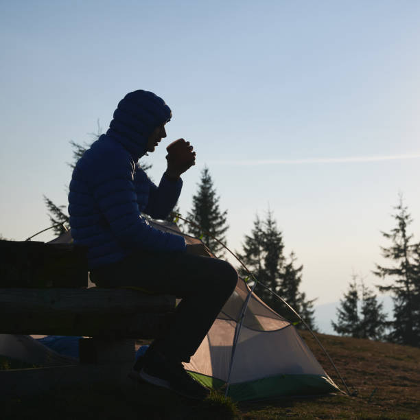 istock One man having rest in campsite in fresh air. 1313110282