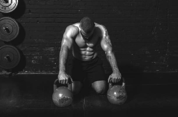 istock Young active sweaty strong muscular fit man with big muscles preparing for kettlebell workout in the gym as hardcore workout cross training real people exercise 1313110699