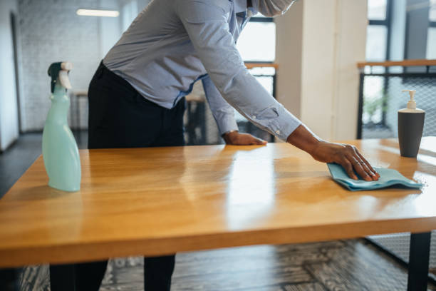 istock Businessman disinfecting desk in office 1313112855