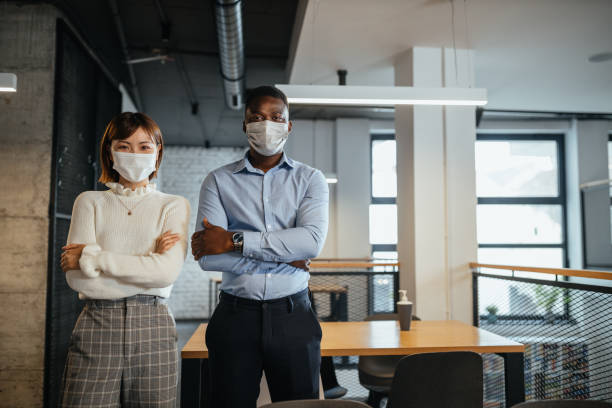 istock Mixed race colleagues at work during pandemic 1313114203
