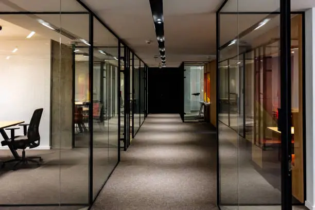 Photo of Empty corridor in modern office building at night