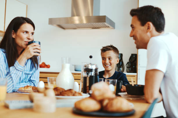 istock Smiling family eating breakfast together 1313115415