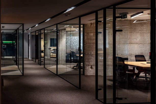 Modern open office with reception and glass partition Photo Of Empty Modern office at the design company at night, covid-19 concept. office cubicle no people stock pictures, royalty-free photos & images