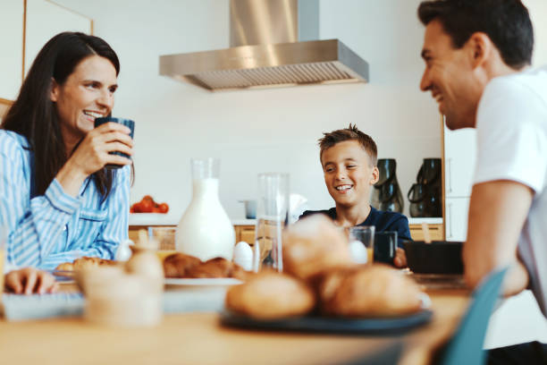 istock Family laughing together at breakfast 1313115679