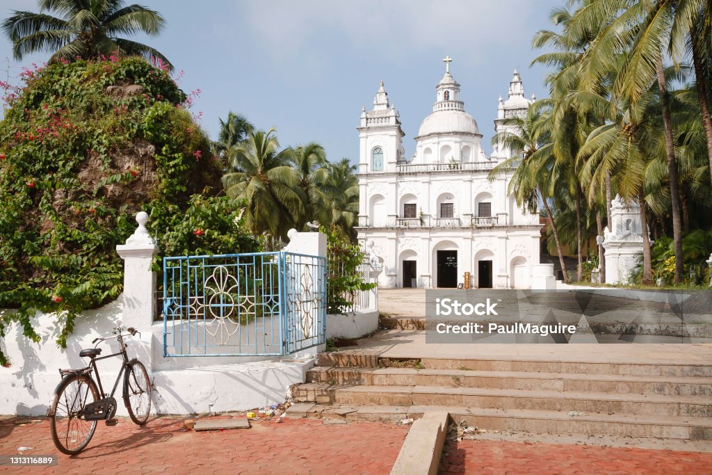 Church of St Alex, Calangute, Goa, India Bicycle outside the Church of St Alex, a large Catholic Christian church in Calangute, North Goa, India Panjim Stock Photo