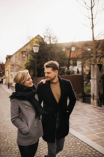 istock Friendly young couple walking down a cute street 1313118204