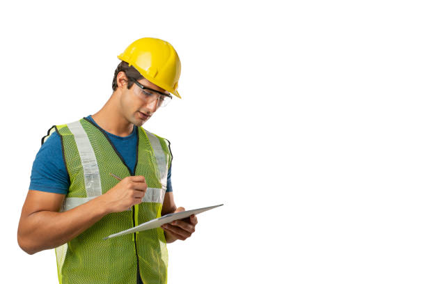 istock Manual worker in yellow helmet and shirt using a digital tablet, isolated on white, copy space for text. 1313122187