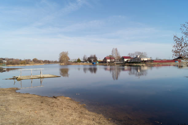 istock Spring flood in the countryside against a blue sky with white clouds 1313123780