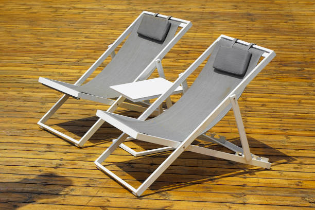istock Two lounge chair on an exotic wood terrace 1313123917