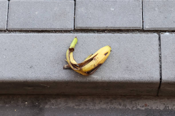 istock Yellow banana peel on a paved road. 1313125088