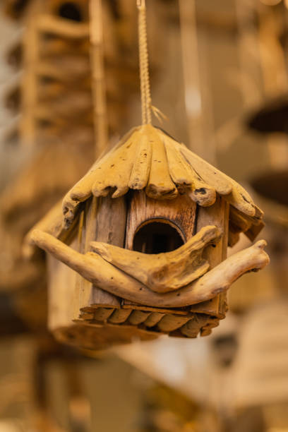 istock handmade wooden bird nest hanging in a tree 1313125235