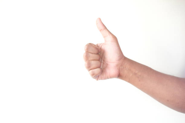 istock man hand showing a thumb-up on white wall 1313125342