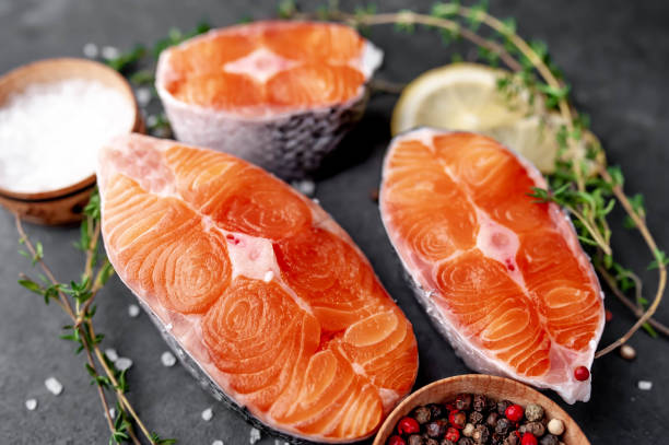 istock fresh raw salmon steaks on a stone background with salt, pepper, tomatoes, lemon 1313126127