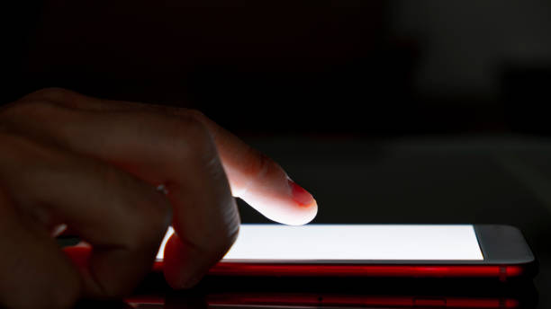 istock Close-up of a man using his smartphone at night. 1313128990