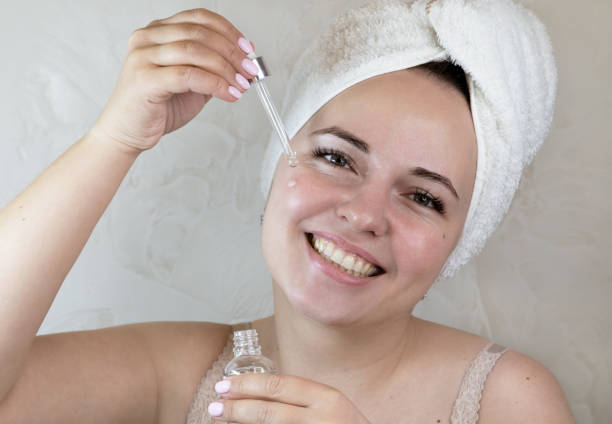 istock Young  woman uses face serum. 1313133735