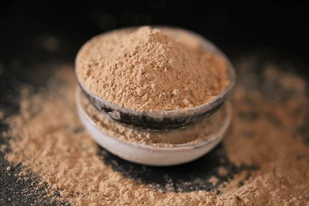 istock Maca powder in ceramic cups set on black background. Peruvian ginseng.peruvian Maca powder close-up. Super food. Natural energetic. Healthy natural products. Lepidium meyenii 1313133773