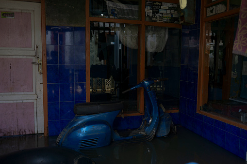 BANDUNG, WEST JAVA, INDONESIA - 28 MARCH : A motorcycle submerged by flooding 28 March 2021 in Kampung Jembatan, Baleendah village, Beleendah District, Bandung Regency, West Java.
Floods that occur every rainy season in South Bandung has been going on for a long time, historically citarum major floods occurred in 1931, 1986 and 2017 which resulted in thousands of submerged houses. Various efforts were made by the government, from normalization and dredging of rivers, to the creation of water retention ponds in 2018. Billions of budgets were rolled out for the preemptive measures, but flooding is still happening.