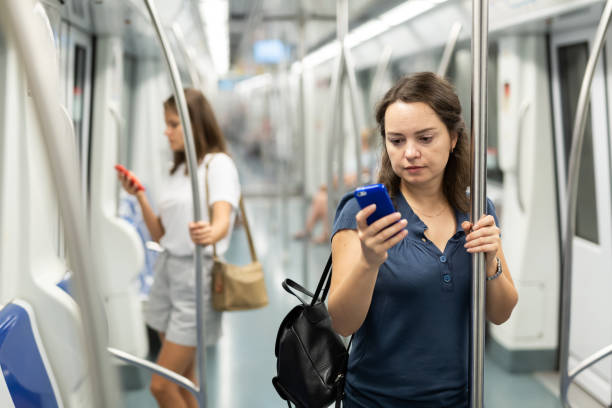 istock Positive woman reading from mobile phone screen in metro 1313134943