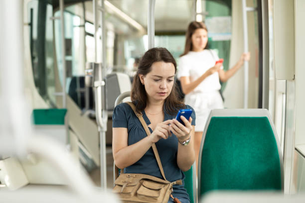 istock Woman using phone in city bus 1313134962