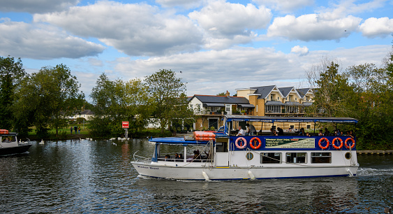 Windsor, United Kingdom - August 31 2020:  The River Cruise boat Windsor Royal cruising along the Thames past Barry Avenue
