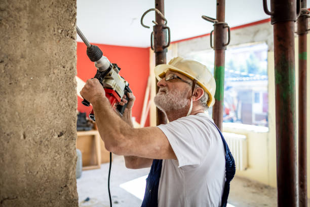 istock Senir man using drilling machine on a reconstruction of his home 1313135507