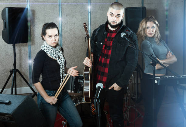 istock expressive group of rock musicians posing with instruments 1313136874
