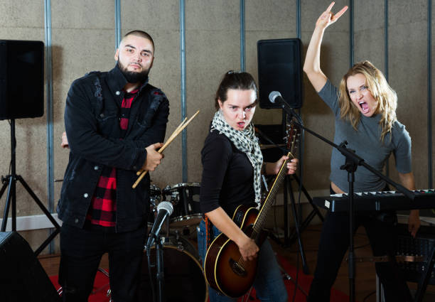 istock group of rock musicians posing with instruments 1313136881