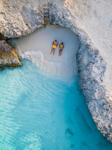 Tres Trapi Steps Triple Steps Beach, Aruba completely empty, Popular beach among locals and tourists, crystal clear ocean Aruba. Caribbean, couple man and woman in a crystal clear ocean