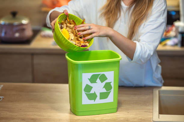 istock Millennial woman putting organic waste in compost bin. 1313140625