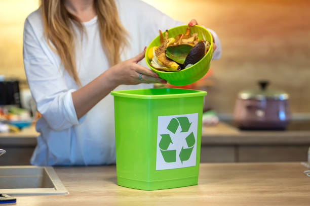 istock A young girl throws vegetable cuttings in a compost bucket. 1313140676