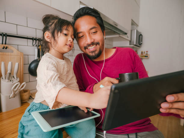 istock Asian hipster man working on digital tablet at home. 1313144248