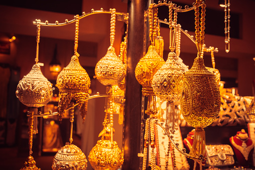 Selection of gold colored decorative items for sale in a souk