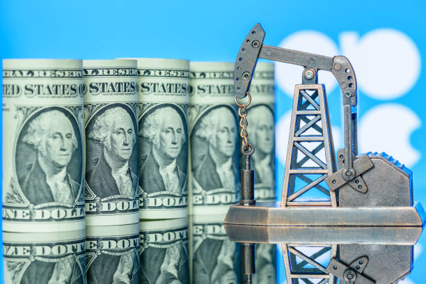 US one dollar banknotes, a pumpjack and flag of OPEC behind Petroleum, petrodollar and crude oil concept opec stock pictures, royalty-free photos & images