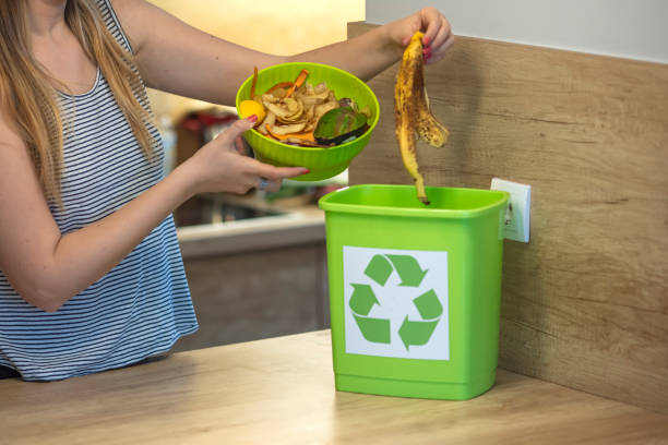 istock A young girl throws vegetable cuttings in a compost bucket. 1313152495