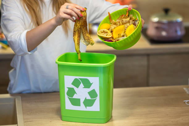 istock Close Up Of Woman Making Compost From Vegetable Leftovers In Kitchen 1313152687