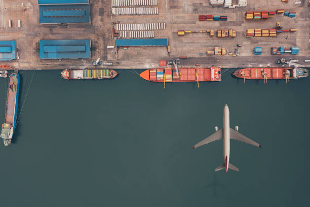 istock Cargo airplane flying over container ship in the ocean. 1313153497