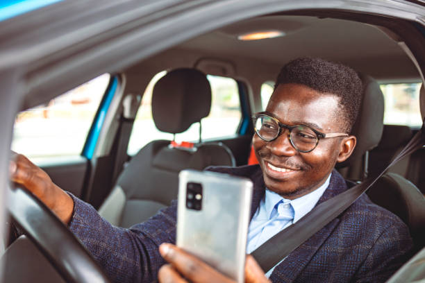 istock Businessman in Car Reading Message on Smartphone 1313154586