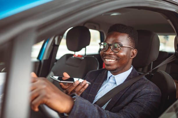 istock Handsome Businessman Talking on the Phone while Driving a Car to Work. 1313155694